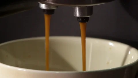 Close-up, process of pouring coffee into a white cup from a coffee machine Stock Footage 83096315