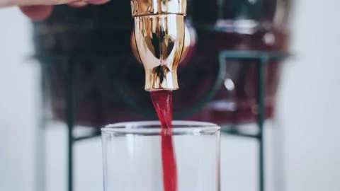 Close-up of the process of pouring morse from a decanter with a tap Stock Footage 159912843