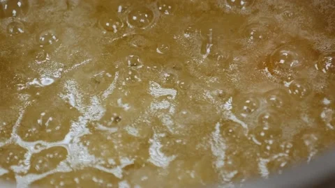 Close-up of the process of preparing caramel, caramel boils in a pan in kitchen Stock Footage 136833552