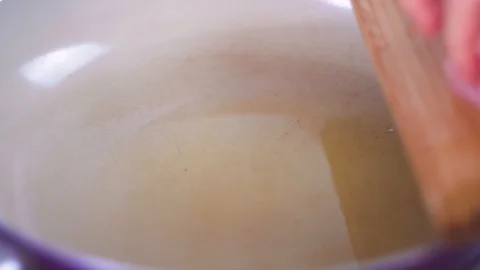 Close up, the process of putting in boiling olive oil in the pan large pieces of Stock Footage 108033607
