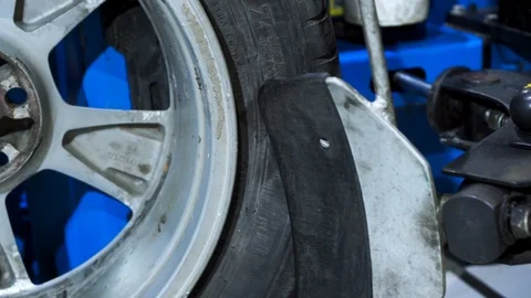 Close up of the process of removing tire from rim. Footage. Stockbeeldmateriaal 127545480