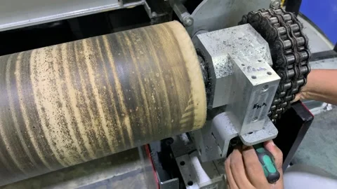 Close up of a process repairing rotating industrial roller mounted Stock Footage 346360182