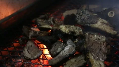 Close up of the process of roasting lamb in hot coals Stock Footage 267680884