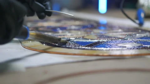 Close-up The process of soldering stained glass seams. Gloved hands with a Stock Footage 161407726