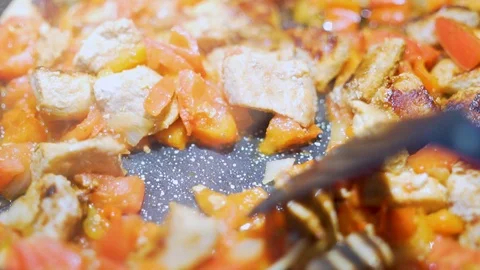 Close-up of the process of stirring a delicious boiling steaming meat meal with  Stock Footage 119263997