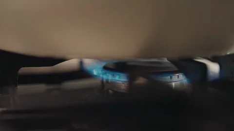 Close-up process of turning on and turning off gas for heating up sunflower oil Stock Footage 312233922