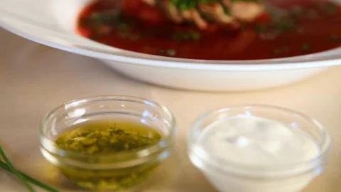 Close-up of the process of watering with garlic oil borscht with meat and finely Stock Footage 124654307