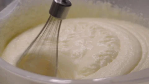 Close-up, the process of whipping buttercream with a hand mixer Stock Footage 337118124