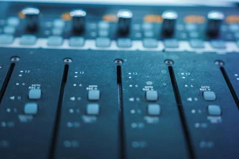 Close Up of Professional Audio Mixing Console with Faders and Knobs Stockfoto's