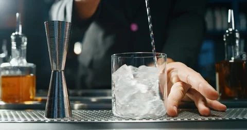 Close up of a professional bartender is serving an alcoholic cocktail. Stock Footage 121539148