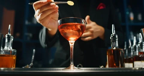 Close up of a professional bartender is serving an elite alcoholic cocktail Stock Footage 121539168