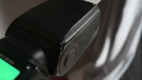 Close-Up of a Professional On-Camera Flash Speedlight Powering On with Sound Stock Footage 339280719
