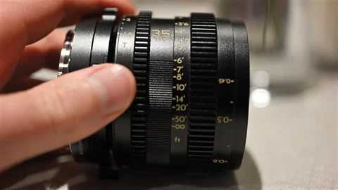 Close up of professional camera lens with aperture and focus rings being Stock Footage 331013297