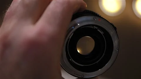 Close up of professional camera lens with aperture and focus rings being 스톡 동영상 331014688