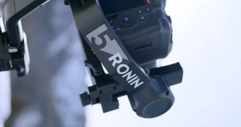 Close-up of a professional camera on a motorized gimbal, backlit by sun flare Vídeo Stock 345021938