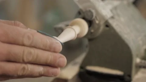 Close-up of a professional carpenter using sandpaper to grind a piece of wood Stock Footage 139446698