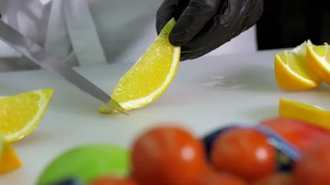 A close-up of a professional chef in black gloves in the kitchen of a restaurant Stock Footage 168968304