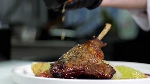 Close-up of a professional chef in black gloves in a restaurant kitchen Stock Footage 169056096