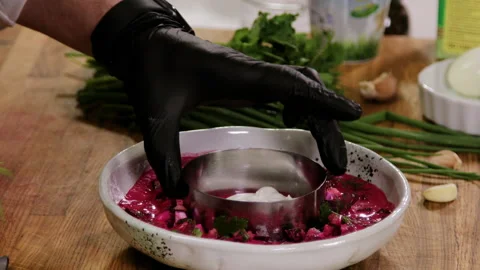 Close up of professional chef cooking a cold soup with yogurt and vegetables. 4K Video stock 136489996