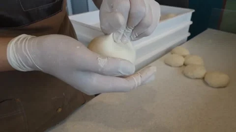 Close-up of professional chef hands in gloves shaping fresh Italian pizza dough Video stock 337677282