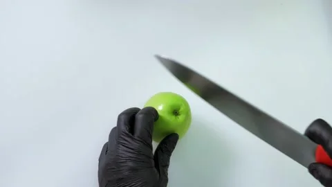 Close-up of a professional chef in the kitchen of a restaurant, cutting an apple Video stock 168967422