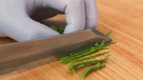 Close-Up Professional Chef Slicing Fresh Green Herbs with Chiffonade Technique o Stock Footage 333500682