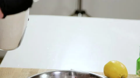 Close up of professional chef sprinkles sugar over the strawberries. 4K Stock Footage 134453923