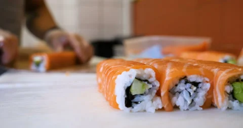 Close-up of professional chef's hands in transparent gloves making sushi Stock Footage 112823116