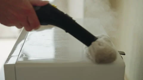 Close-up of professional cleaning service worker disinfecting microwave oven Stock Footage 313221148