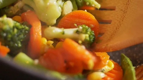 Close-up of professional cook stirring vegetables cooked in the pan. Stock Footage 107437694