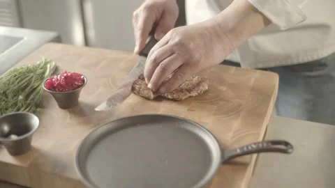 Close-up of Professional Cook Stylishly Serving Steamed Stake on a Plate. Stock Footage 196256702