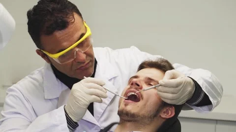 Close up of a professional dentist examining teeth of his patient Video stock 311526128