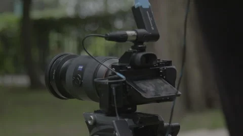 Close-Up of Professional Digital Camera on Tripod Outdoors Stock Footage 342563965