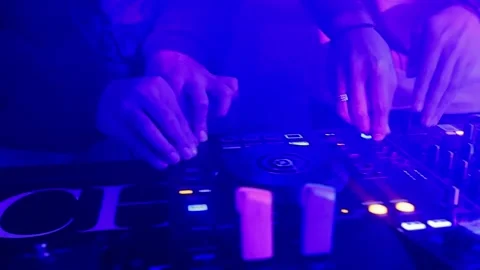 Close-up of professional DJ hands mixing music on a controller at a night club. Stock Footage 328279323