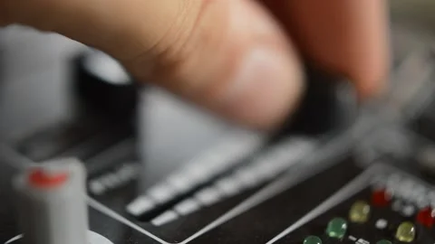 Close-up professional dj turn down the volume of the mixer audio for music Video stock 197977393