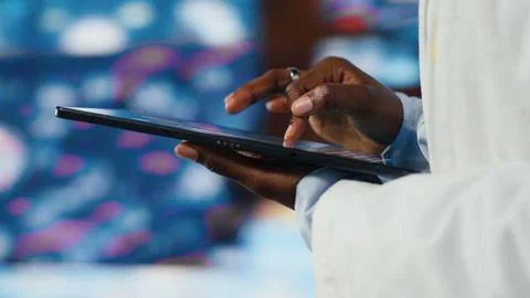 Close up of professional doctor using tablet to look at medical data charts Stock Photos