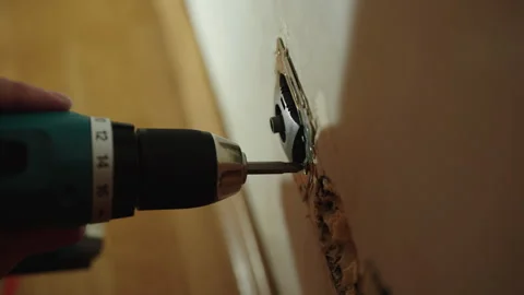 Close-up of professional electrician removing electrical outlet with cordless Stock Footage 306000575