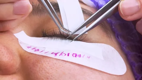 Close-up of a professional eyelash extension procedure. Stock Footage 337554288