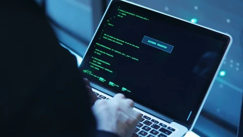 Close-up professional hacker coding on laptop showing access granted on monitor Stock Footage 120693490