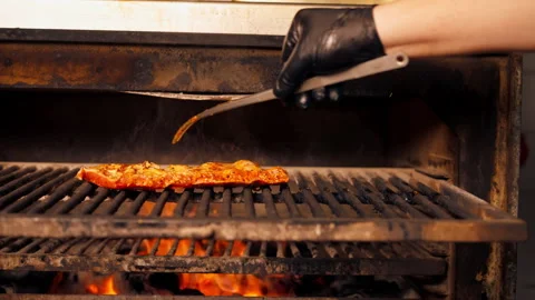 Close up in a professional kitchen chef in a black jacket lays out marinated Stock Footage 276301602