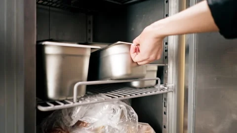 Close-up in professional kitchen, the chef takes out the necessary iron Stock Footage 273184977