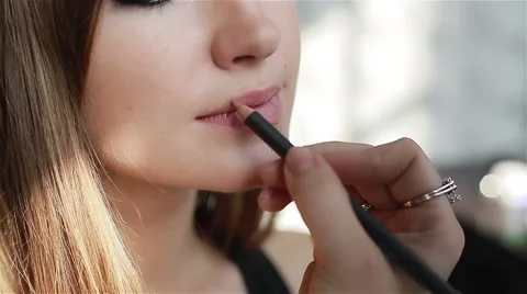 Close-up of professional make-up artist applying contour on lips Stock Footage 52993569