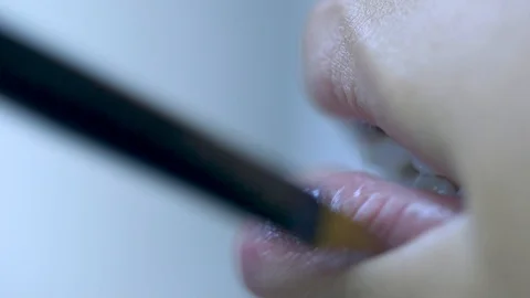 Close-up Of A Professional Makeup Artist Applying Lipstick On Model's Lips Stock Footage 128388577