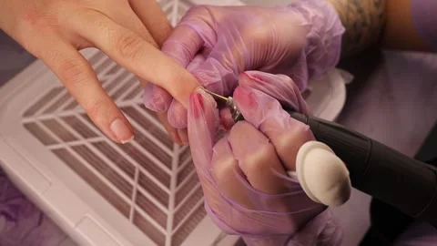 Close up of professional manicure procedure using electric nail drill. Nail Vidéo 329549731