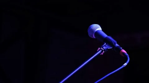 Close-up of Professional Microphone on empty dark stage on a black background. Video stock 155529405