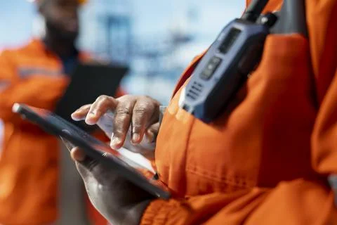 Close up of professional on offshore platform deck configuring derrick systems Stock Photos
