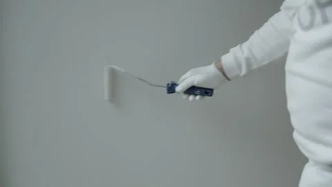 Close-Up of Professional Painter Applying White Paint with Roller on Interior Stock Footage 336247105