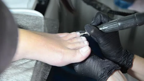 Close Up Professional Pedicure Removing Old Gel Polish with Electric Nail Drill Stock Footage 340820519