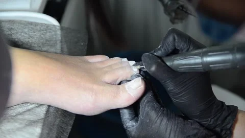 Close Up Professional Pedicure Removing Old Gel Polish with Electric Nail Drill Stock Footage 340820520