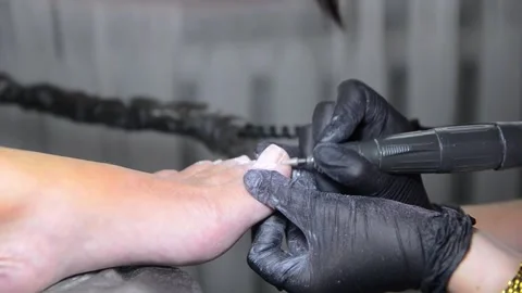 Close Up Professional Pedicure Removing Old Gel Polish with Electric Nail Drill 動画素材 340820526